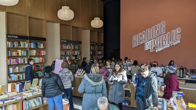 Reading in Public Bookstore + cafe people inside buying books