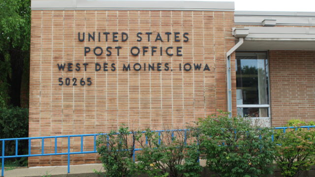The front entrance to the brick United States Postal Office in West Des Moines, Iowa