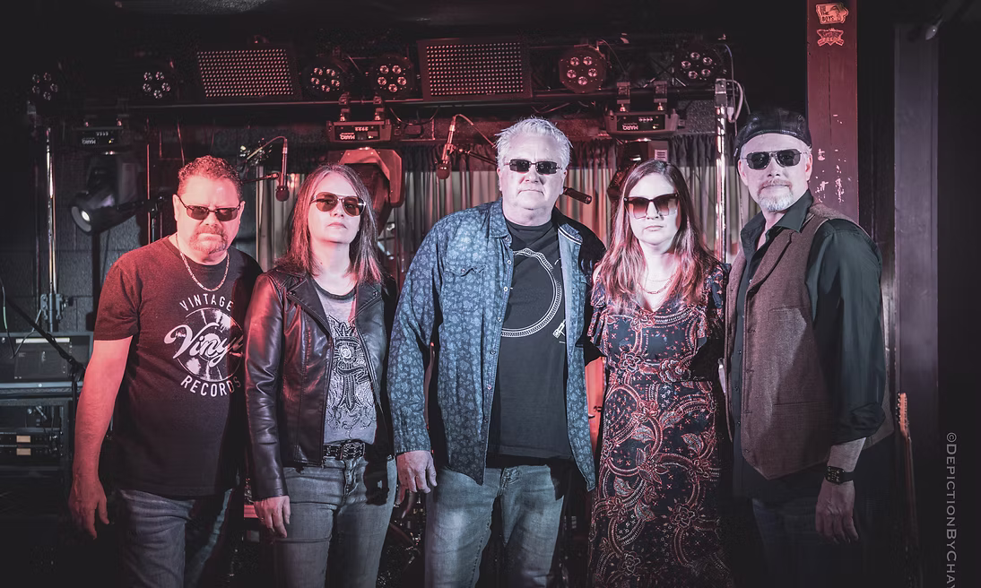 kinda petty band 5 members standing in bar